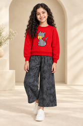 Red cat sweatshirt replacing the ivory top, paired with charcoal trousers