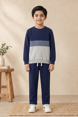 Smiling 8-year-old Pakistani boy wearing the navy and grey co-ord set
