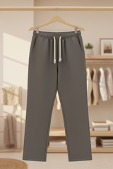 Ash-grey trousers displayed in a cosy boutique winter setting