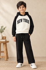 Seven-year-old boy wearing the New York hoodie and black open-hem drawcord trousers